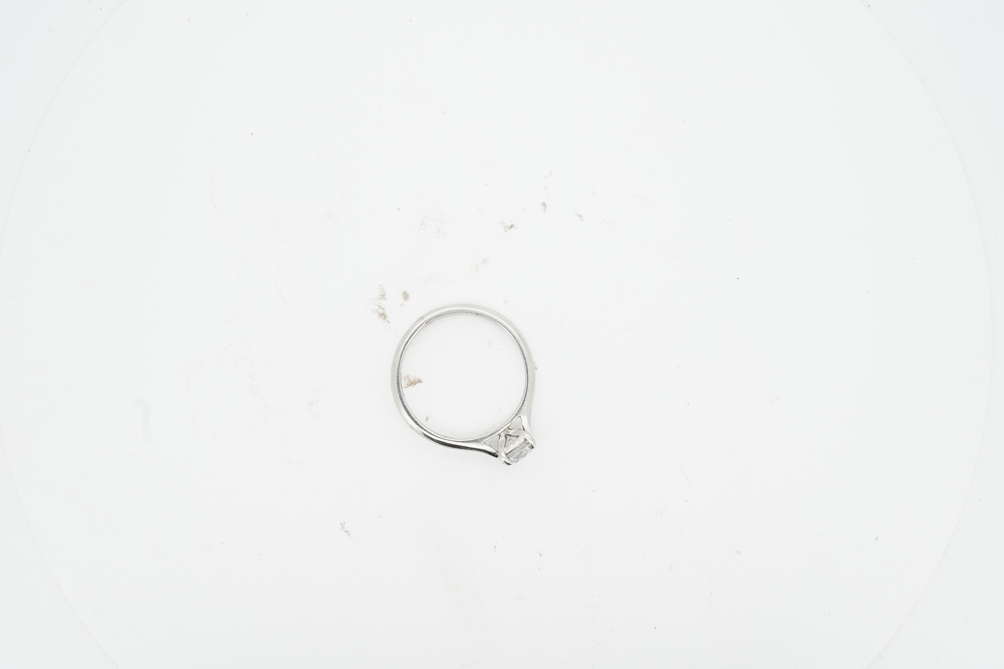 A diamond ring, claw-set with a brilliant-cut diamond weighing approximately 0.61 carats, mounted in platinum, size L, British hallmarks, gross weight approximately 3 grams